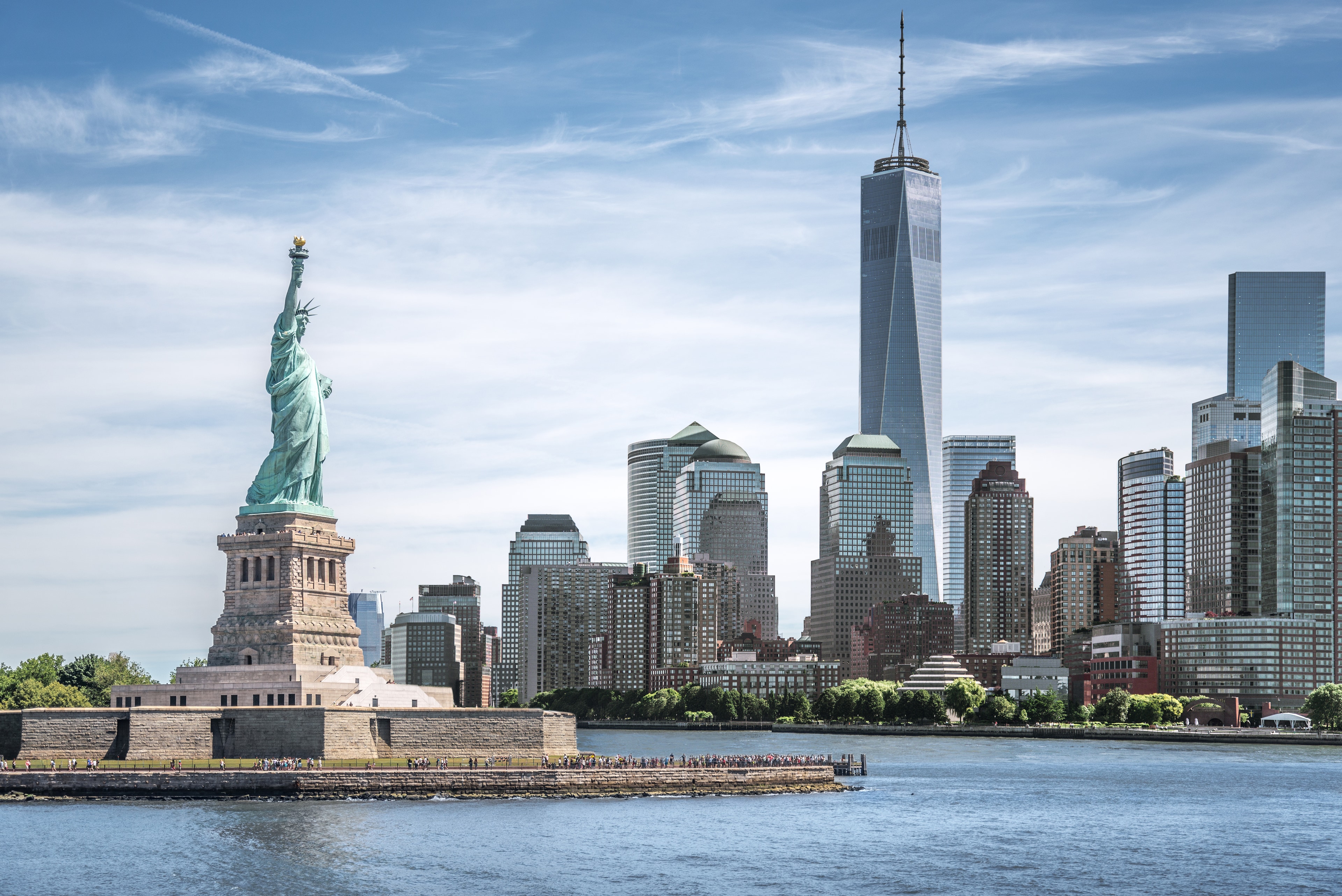 Statue of Liberty with One World Trade Center and Lower Manhattan skyline